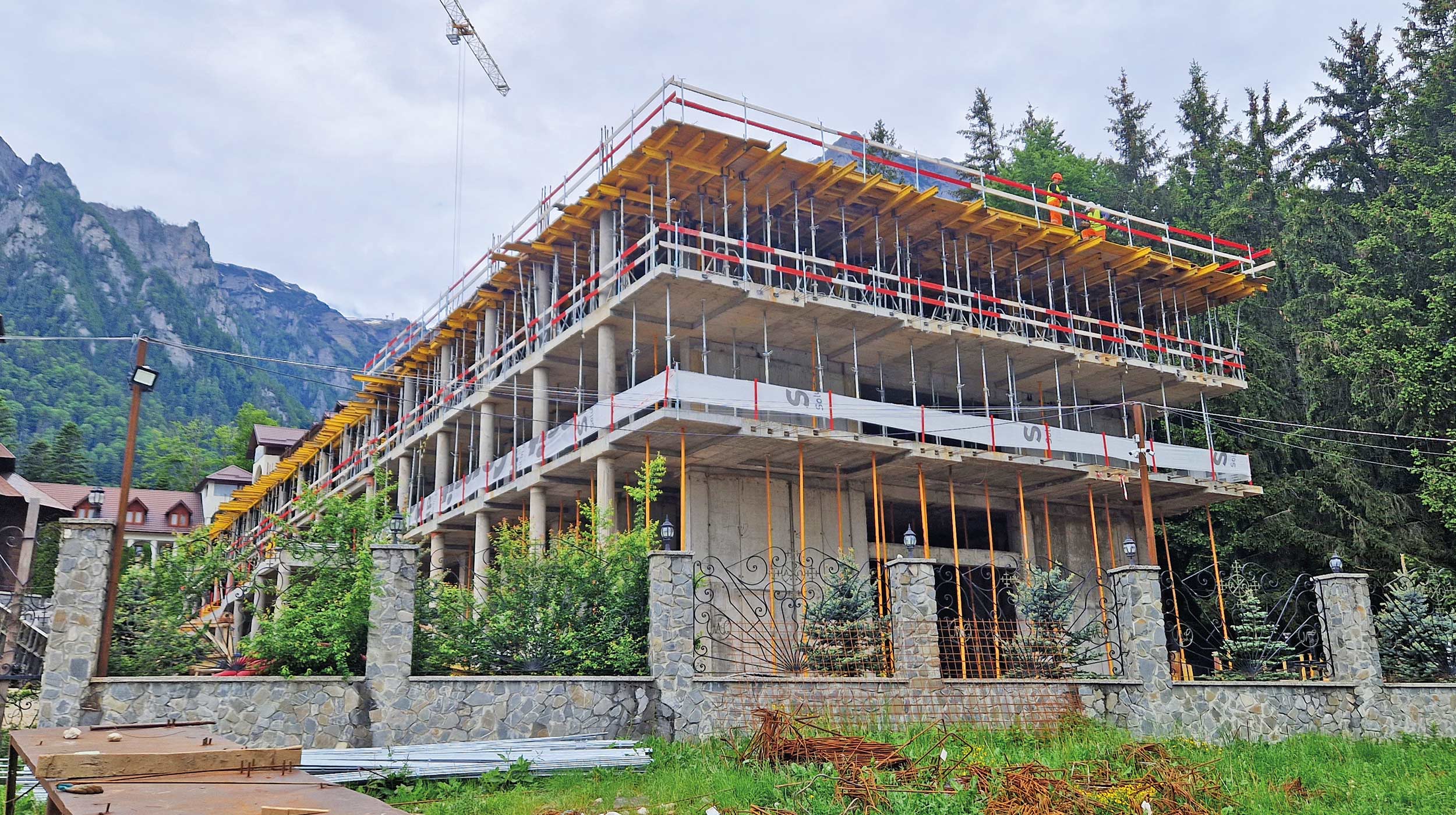 The “Holy Cross” Social and Pastoral Center of Caraiman Monastery is currently undergoing expansion through the construction of a new building, adjoining the existing facility. The project is developed on sloping terrain, with the structure starting from level -3 and comprising three basement, ground floor, and two upper levels. The “Holy Cross” Social and Pastoral Center of Caraiman Monastery is currently undergoing expansion through the construction of a new building, adjoining the existing facility. The project is developed on sloping terrain, with the structure starting from level -3 and comprising three basement, ground floor, and two upper levels.