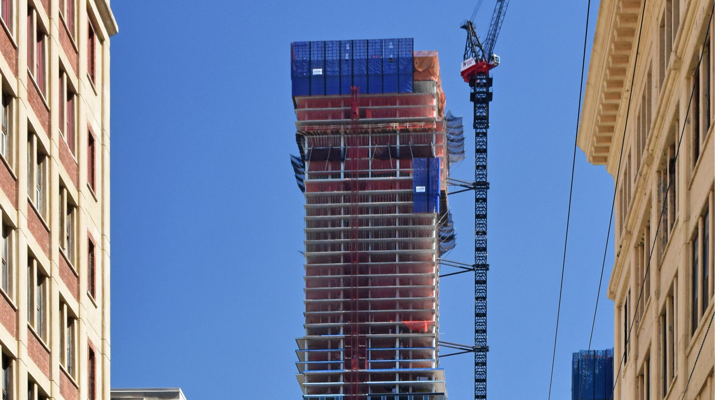 A series of buildings are being constructed along the banks of the Hudson River with spectacular views of Manhattan.